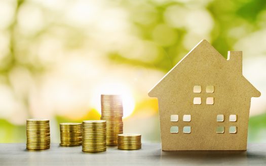House Model and Golden Coins Stacks with blur Background.Savings Plans for Housing,Finance and Banking about House concept.